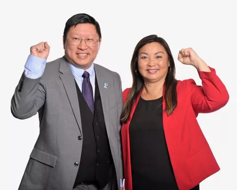 Kane Tse and Lily Chang, posing with a raised fist.
