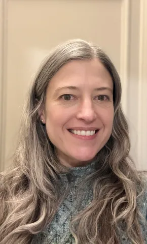 A headshot of a smiling woman. 