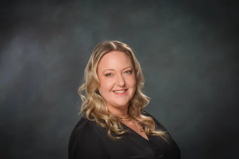 A headshot of a woman smiling. 
