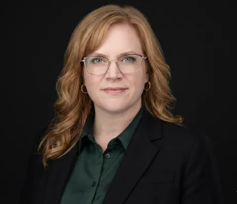 A headshot of a smiling woman. 