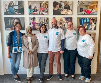 Six smiling people wearing HSA t-shirts or scarves.