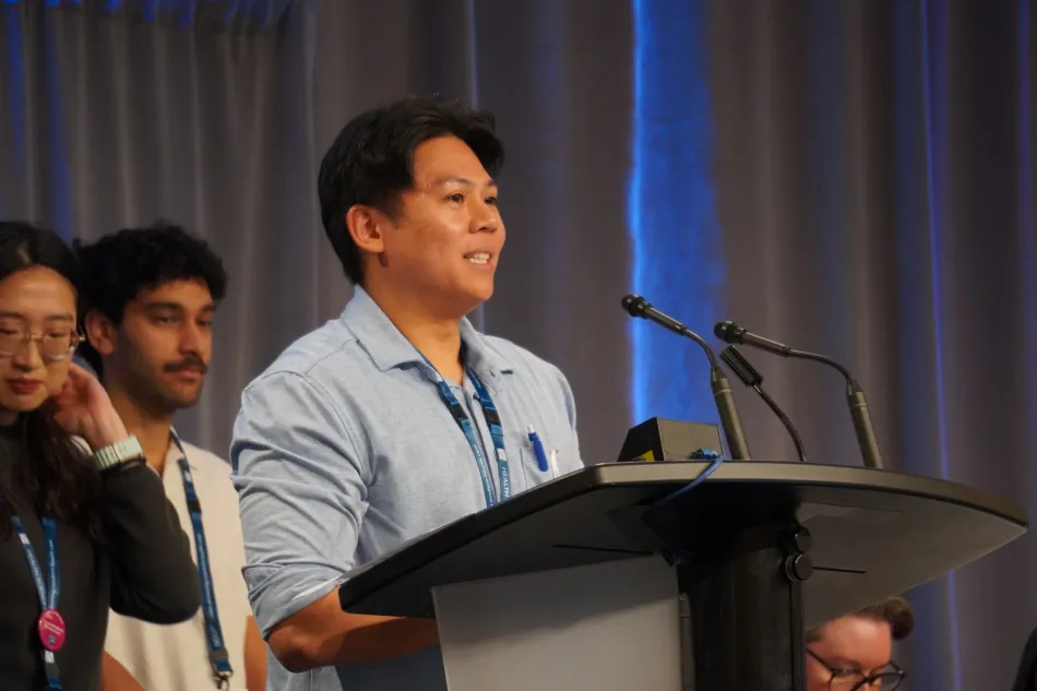 Gian speaks at a podium during HSA Convention 2026. 