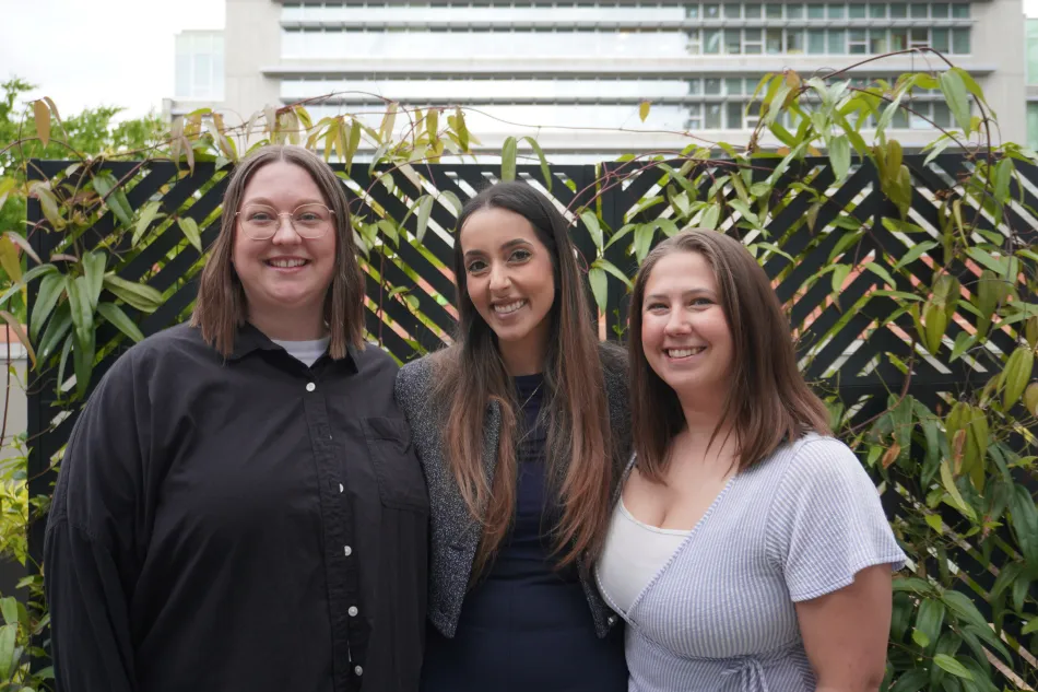 Lisa Daechsel, Sarah Kooner, and Hannah ALlen pose for a photo outside of HSA's offices. 