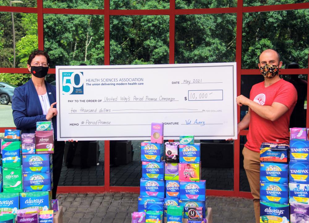 Val Avery and Neal Adolph holding a cheque